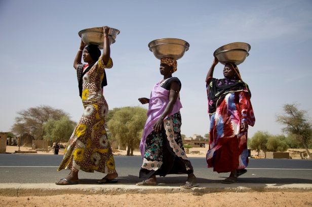 Senegal, Saint Louis, Podor, Donay village, women going to rice mill
